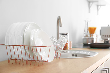 Set of clean dishware near kitchen sink