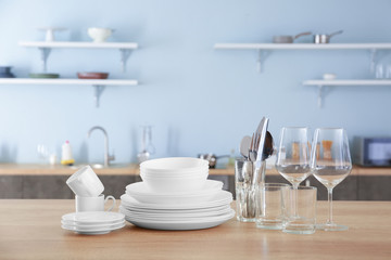Set of clean dishware on kitchen table