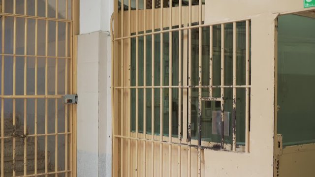 security checkpoint in a prison with metal bars and a video camera