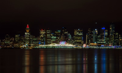 Fototapeta premium The downtown Vancouver skyline at night from North Vancouver. Canada Place and Tower Illuminated with Christmas stile
