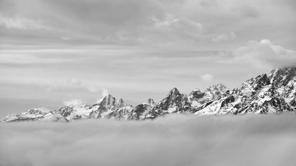 Black and white picture of Grand Teton mountain range in clouds, Wyoming, USA.