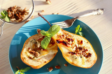 Ready-made dessert of baked pears, dor blue cheese, nuts and honey. Vegetarian pear dessert in a...