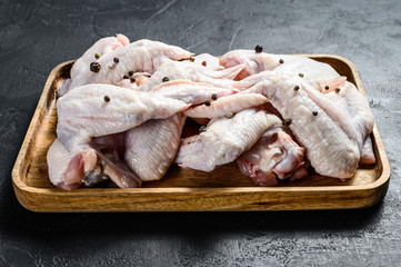 Raw chicken wings. Farm organic poultry. Top view. Black background.
