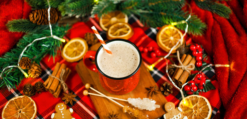 Christmas greeting card. Cacao drink in enamel cup with garland, fir branches, dried orange slices,...