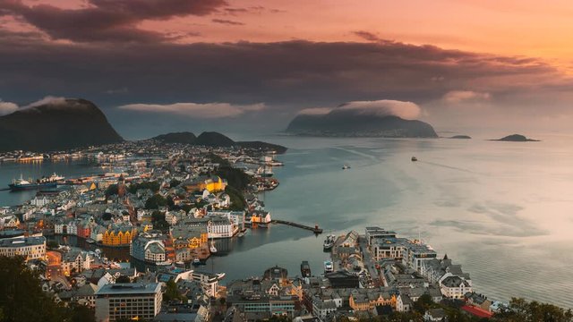 Alesund, Norway. Day To Night Time-lapse. Dramatic Sky In Warm Colours Above Alesunds Islands In Sunset Time. 4K. Famous Town In Evening Night Time