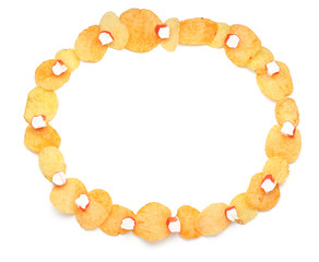 Frame made of tasty potato chips and crab sticks on white background