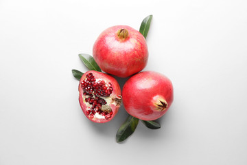 Ripe juicy pomegranates on white background