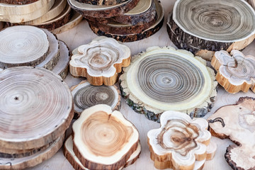 Wooden hot stands made from tree trunk slices on the counter. Kitchenware from natural materials. Selective focus, close-up