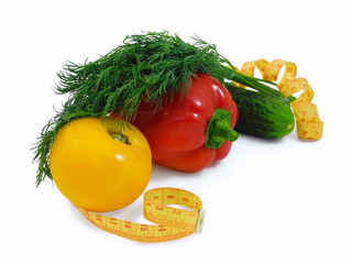 Fresh yellow tomato, red pepper, cucumber and bunch of dill with measuring tape isolated on white background. Diet food concept.