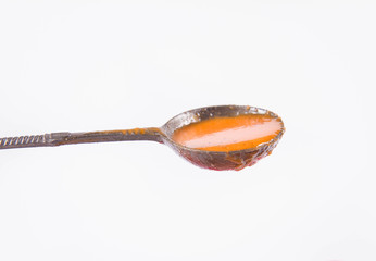 Gazpacho soup on a white background on a vintage spoon