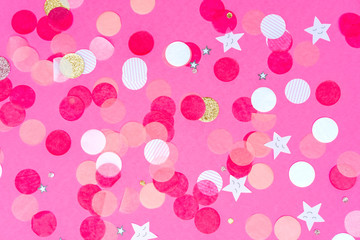 Fototapeta na wymiar Multicolor pink, gold and white confetti on the bold pink background, holiday celebration backdrop, Flat lay style