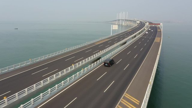 Flying over massive Jiaozhou Bay Bridge project, a modern highway spanning 25.9 kilometres connecting Qingdao with Huangdao, infrastructure and transportation in China