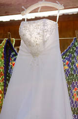 White wedding dress on hanger hanging