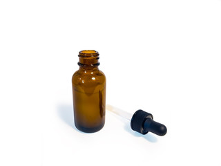 Cannabis extract oil, known as CBD, in an orange tincture bottle on a plain white background