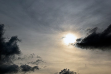 Fototapeta premium The sun at sunset and unusual clouds