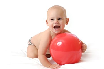 Fototapeta na wymiar Small plump baby paly the red toy ball