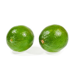 Two fresh lime isolated on a white background