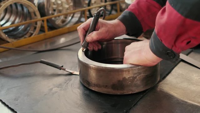 metal work by hands. factory worker engraving