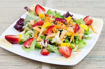 Fresh salad of mixed vegetables and fruits