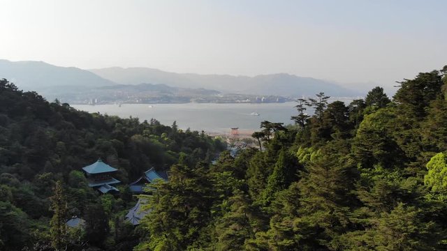 Aerial drone view of Itsukushima Island Torii Gate in Hiroshima Bay, Japan in 4k