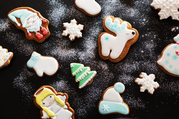 Christmas gift gingerbread on dark background.  Christmas gingerbread cookies with icing sugar. Top view
