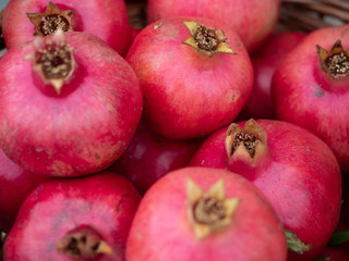 Multiple Ripe Pomegranates at an Outdoor Market
