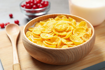 Tasty corn flakes with milk on table, closeup