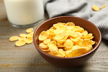 Tasty crispy corn flakes on wooden table