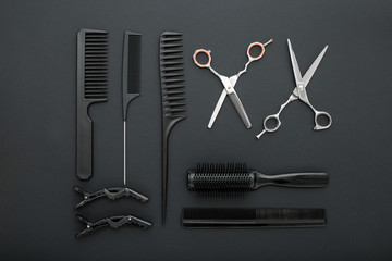 Flat lay composition with Hairdresser tools: scissors, combs, hair iron on black background. Frame. Hairdresser service. Beauty salon service. Hairdresser Set.