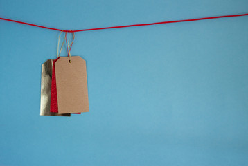 three colorful price tags on rope blue background