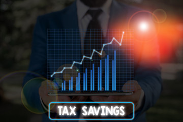 Conceptual hand writing showing Tax Savings. Concept meaning only a portion of income is taxable...
