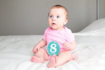 Close up Portrait of Cute 8 Month Old baby Girl with Big blue Eyes, Happy Baby Girl