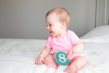 Close up Portrait of Cute 8 Month Old baby Girl with Big blue Eyes, Happy Baby Girl