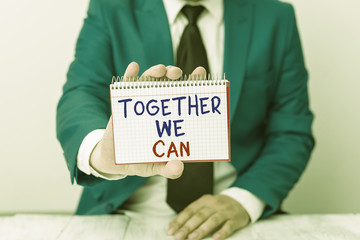 Conceptual hand writing showing Together We Can. Concept meaning unity can makes everything possible One powerful group Man holds empty paper with copy space in front of him Space