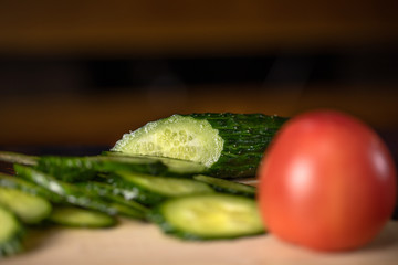 Sliced Cucumber on the wooden board. Cooking