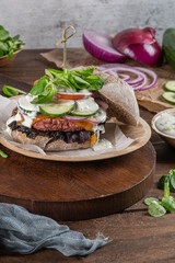 Healthy vegan burger with fresh vegetables and yogurt sauce