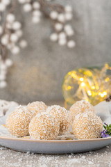 Homemade sweet white chocolate and coconut in a plate. Raffaello candy - snowball truffles on a Christmas table.