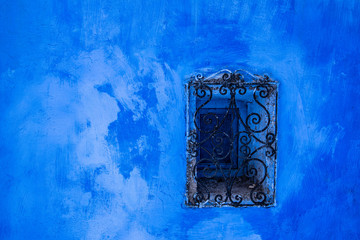 Panoramic view of the old traditional window on the blue wall. Use for the background. Sunny day in blue city Chefchaouen, Morocco.