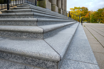 Closeup of the corner of large granite steps. The granite steps are from a government building....