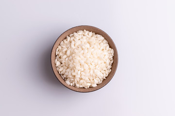 Italian Risotto rice on white background. Copy Space. Soft light. Latin term "Oryza sativa". Carnaroli rice. Vialone Nano rice.