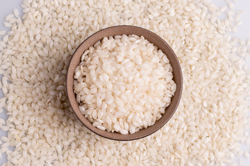 Italian Risotto rice on white background. Copy Space. Soft light. Latin term "Oryza sativa". Carnaroli rice. Vialone Nano rice.