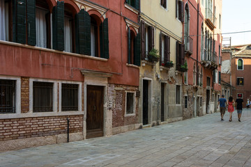 Fototapeta na wymiar Friends walking down a street in Venice, Italy