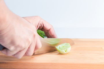Chef hand slicing Cantonese vegetables