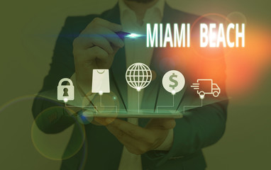 Writing note showing Miami Beach. Business concept for the coastal resort city in MiamiDade County of Florida