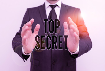 Writing note showing Top Secret. Business concept for protected by a high degree of secrecy Highly confidential Male human with beard wear formal working suit clothes hand
