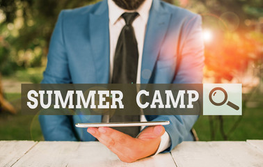 Word writing text Summer Camp. Business photo showcasing supervised program for children conducted during the summer Businessman with mobile phone in his hand