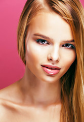 Fototapeta premium young pretty blonde real woman with hairstyle close up and makeup on pink background smiling, stylish fashion look like baby doll