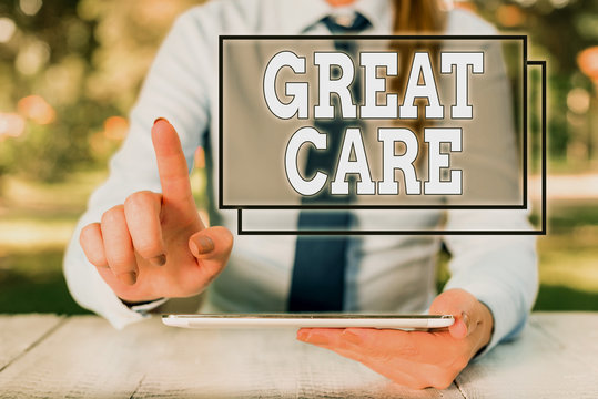Text sign showing Great Care. Business photo text to treat someone with great or excessive care or kindness Female business person sitting by table and holding mobile phone