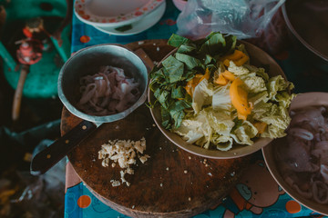 Fresh vegetables and squid rings cooking process in Asian restaurant