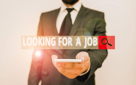 Word writing text Looking For A Job. Business photo showcasing Unemployed seeking work Recruitment Huanalysis Resources Male human wear formal work suit hold smart hi tech smartphone use one hand